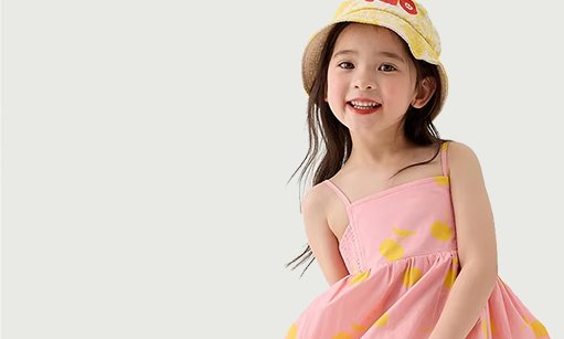 Girl in a pink dress and a yellow sun hat
