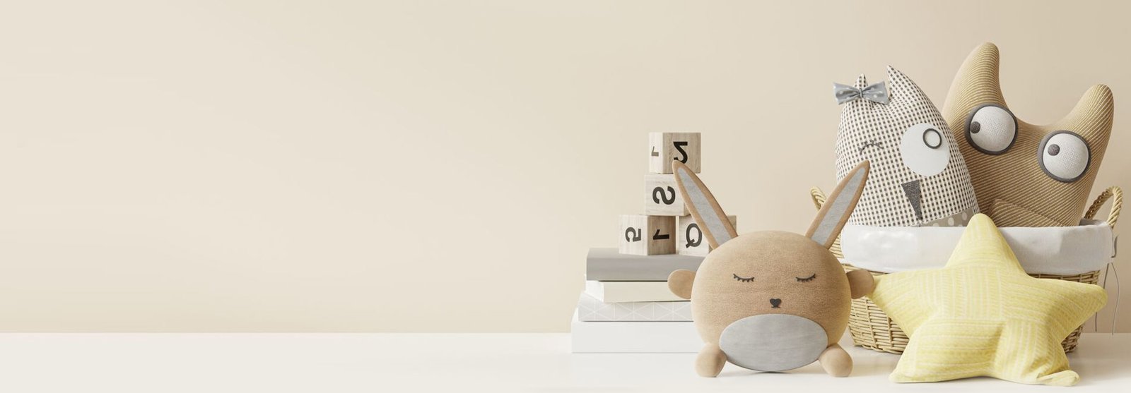Wooden number blocks, a soft toy rabbit and a star cushion on a shelf